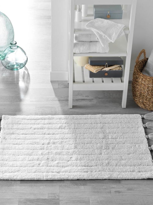 Alfombra de baño lisa y con borlas - Kiabi Alfombra de baño lisa y con borlas - Kiabi