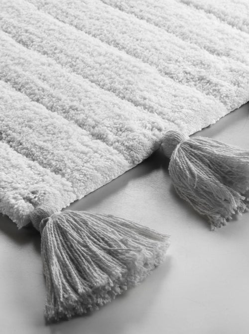 Alfombra de baño lisa y con borlas - Kiabi Alfombra de baño lisa y con borlas - Kiabi