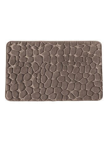 Alfombrilla de baño de espuma viscoelástica con textura de guijarros.