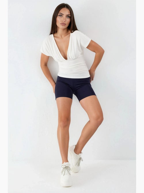 Blusa con cuello en v y detalle de lazo busem - Kiabi Blusa con cuello en v y detalle de lazo busem - Kiabi