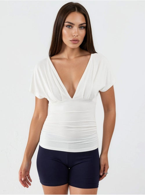 Blusa con cuello en v y detalle de lazo busem - Kiabi Blusa con cuello en v y detalle de lazo busem - Kiabi