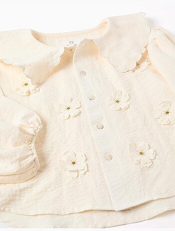 Blusa con mangas abullonadas y aplique floral