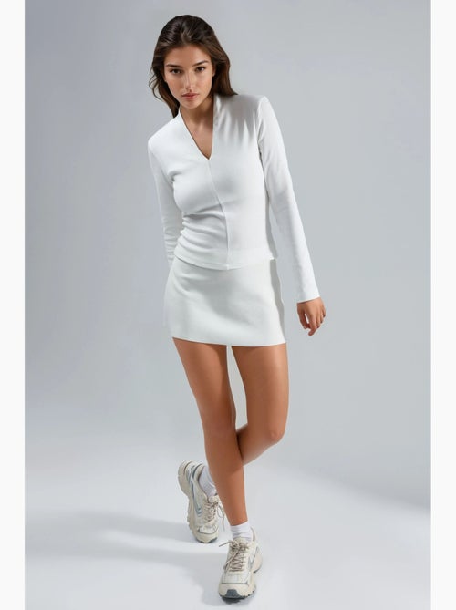 Blusa slim fit de manga larga con cuello en v busem - Kiabi Blusa slim fit de manga larga con cuello en v busem - Kiabi