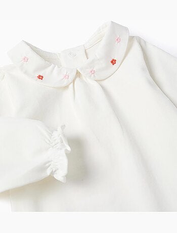 Body de manga larga con flores y volantes