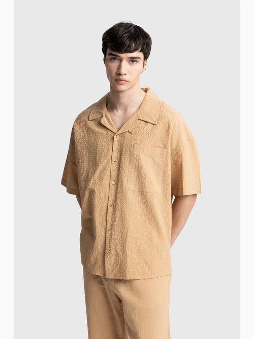 Camisa de algodón texturizado con botones y bolsillo giesto - Kiabi Camisa de algodón texturizado con botones y bolsillo giesto - Kiabi