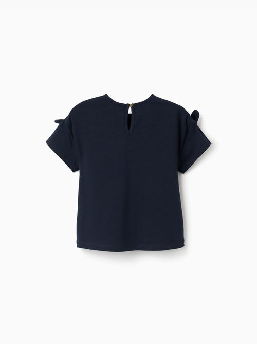 Camiseta con estampado y nudos decorativos - Kiabi Camiseta con estampado y nudos decorativos - Kiabi