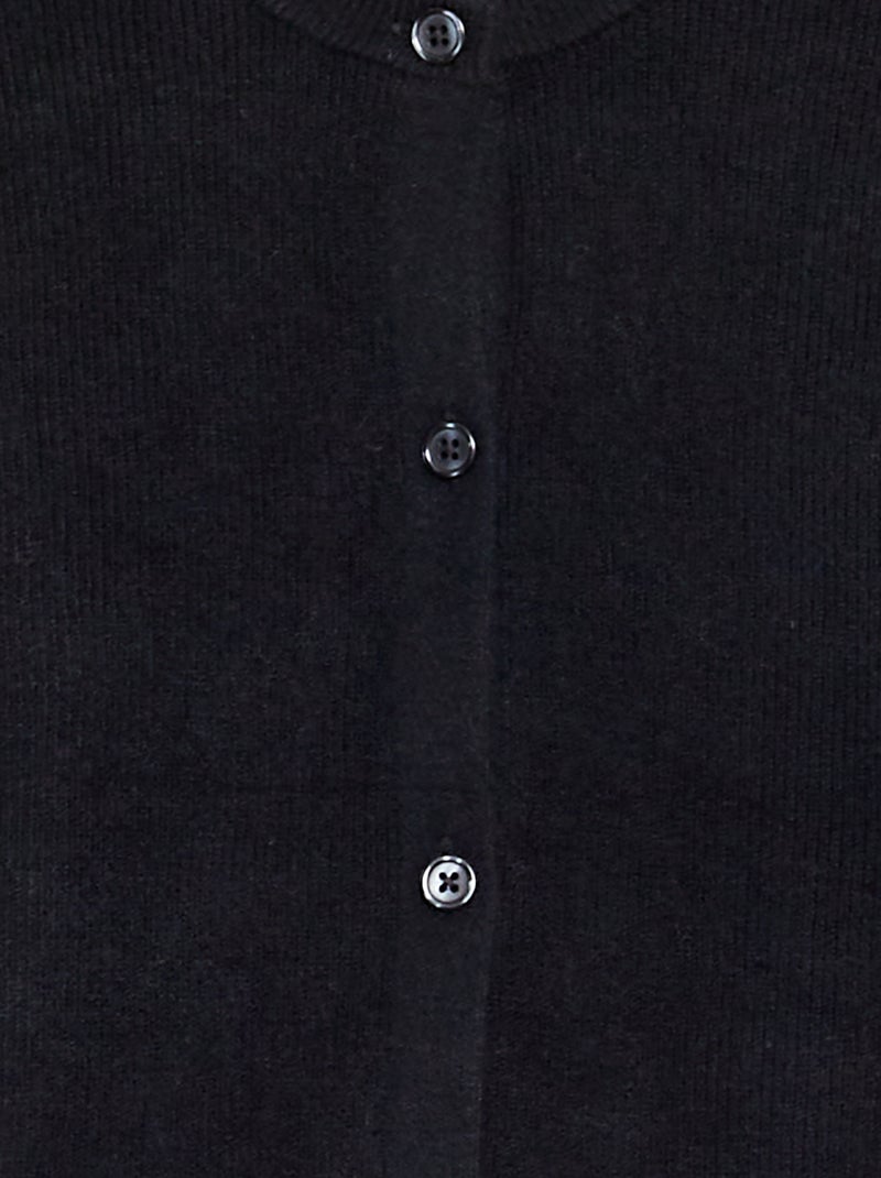 Chaqueta de punto con volantes en los puños negro - Kiabi