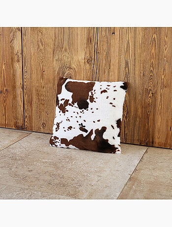Cojín relleno con estampado de piel de vaca y parte trasera de terciopelo