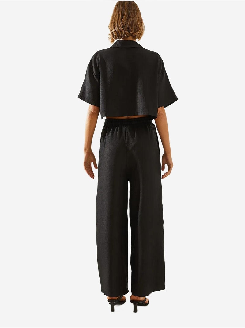 Conjunto de dos piezas con top corto, pantalón abotonado y bolsillos lucci Negro - Kiabi