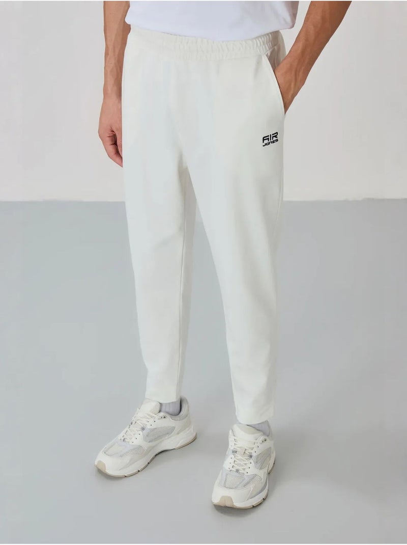 Conjunto de hombre de sudadera con cuello con cremallera y pantalón tommy Blanco roto - Kiabi