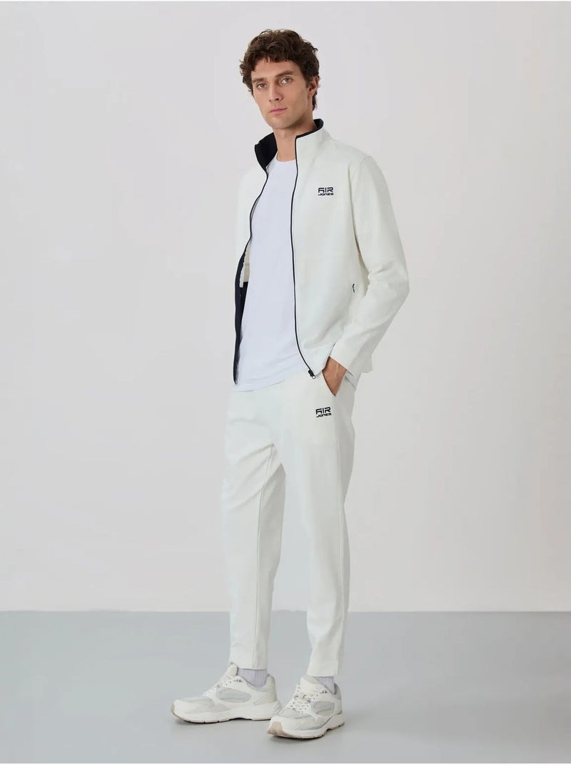 Conjunto de hombre de sudadera con cuello con cremallera y pantalón tommy Blanco roto - Kiabi