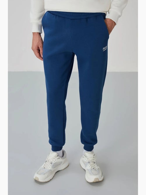 Conjunto de hombre de sudadera y pantalón de felpa de algodón y poliéster tommy - Kiabi Conjunto de hombre de sudadera y pantalón de felpa de algodón y poliéster tommy - Kiabi