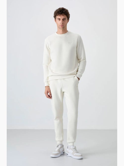 Conjunto de hombre de sudadera y pantalón de felpa de algodón y poliéster tommy - Kiabi Conjunto de hombre de sudadera y pantalón de felpa de algodón y poliéster tommy - Kiabi