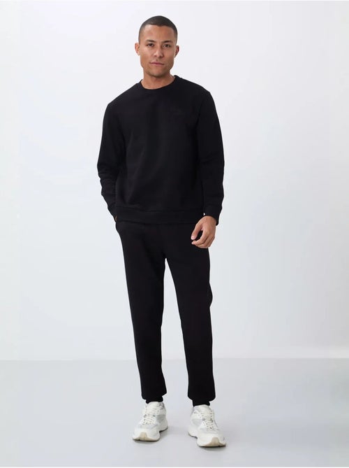 Conjunto de hombre de sudadera y pantalón de felpa de algodón y poliéster tommy - Kiabi Conjunto de hombre de sudadera y pantalón de felpa de algodón y poliéster tommy - Kiabi