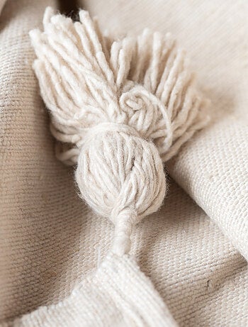 Funda de sofá grande de lana con borlas