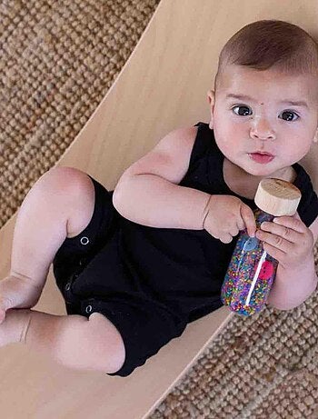 Juguete botella sensorial para bebé con sonido | Petit Boum