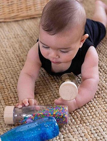 Juguete botella sensorial para bebé con sonido | Petit Boum