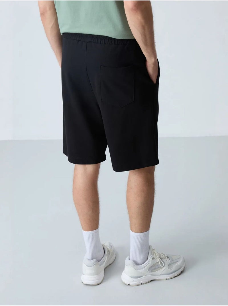 Pantalón corto de felpa para hombre de mezcla de algodón tommy Negro - Kiabi