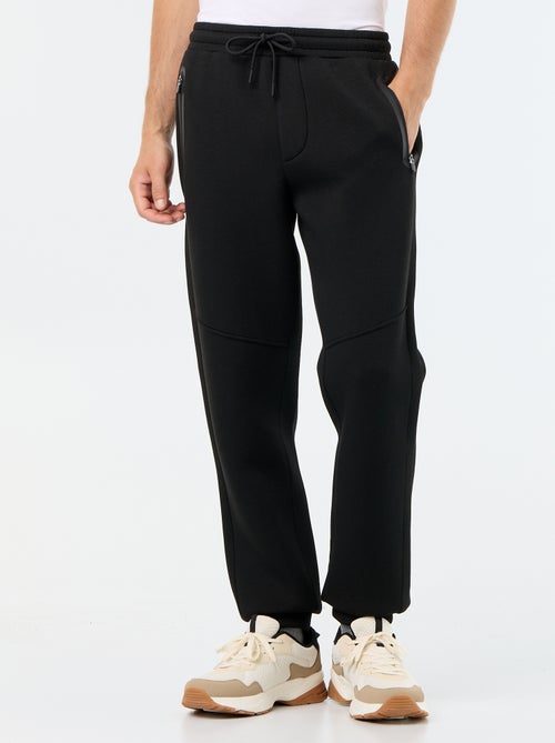 Pantalón de chándal con bolsillos con cremallera - Kiabi Pantalón de chándal con bolsillos con cremallera - Kiabi