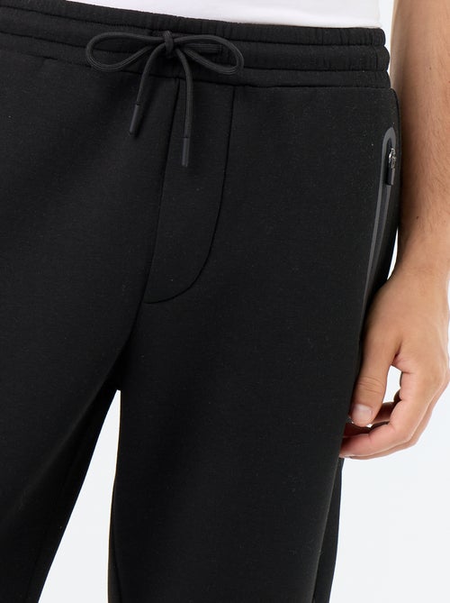 Pantalón de chándal con bolsillos con cremallera - Kiabi Pantalón de chándal con bolsillos con cremallera - Kiabi