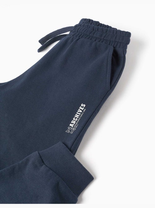 Pantalón de chándal de felpa con bolsillos y estampado ZY - Kiabi Pantalón de chándal de felpa con bolsillos y estampado ZY - Kiabi