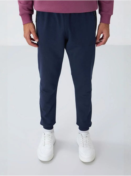 Pantalón de chándal jogger de hombre con bolsillo con cremallera tommy - Kiabi Pantalón de chándal jogger de hombre con bolsillo con cremallera tommy - Kiabi