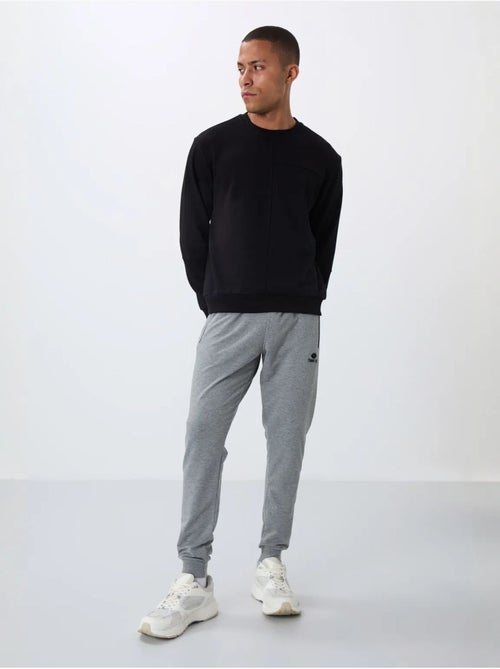 Pantalón de chándal jogger de hombre con bolsillo con cremallera tommy - Kiabi Pantalón de chándal jogger de hombre con bolsillo con cremallera tommy - Kiabi