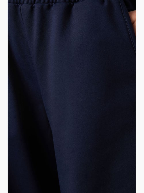 Pantalón de chándal pull-on de pernera ancha tommy - Kiabi Pantalón de chándal pull-on de pernera ancha tommy - Kiabi