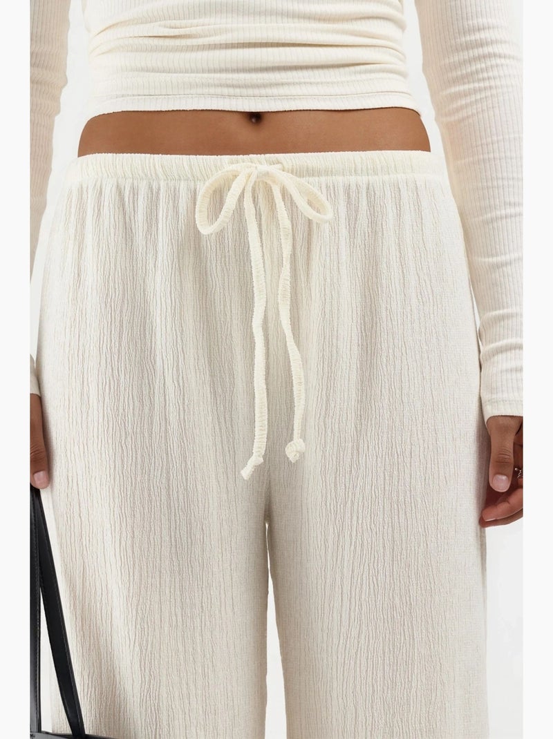 Pantalón de pernera ancha con cintura de cordón busem Crema - Kiabi