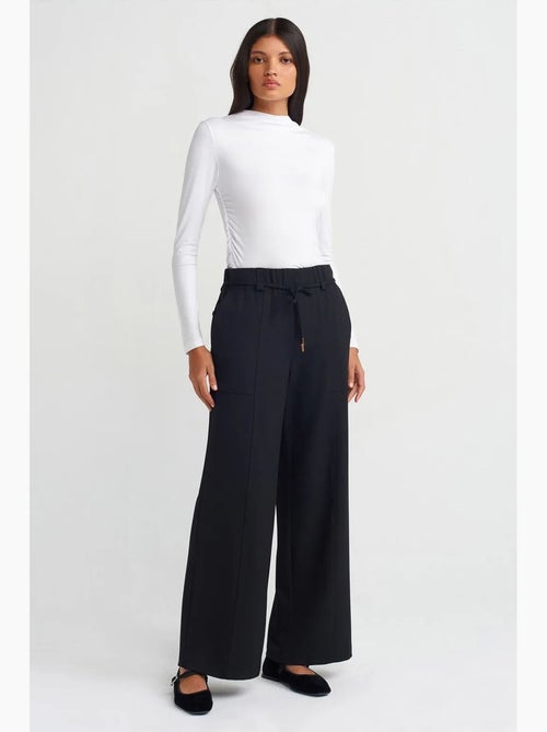 Pantalón de pernera ancha de tejido con cintura elástica y cordón ajustable dilvin - Kiabi Pantalón de pernera ancha de tejido con cintura elástica y cordón ajustable dilvin - Kiabi