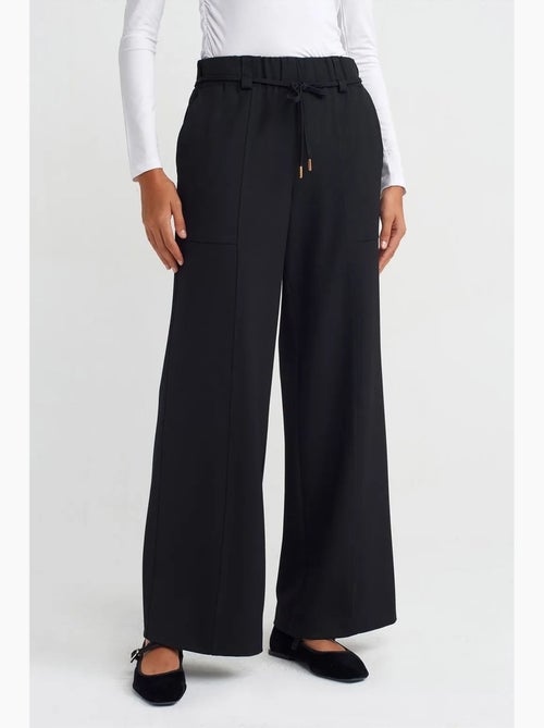 Pantalón de pernera ancha de tejido con cintura elástica y cordón ajustable dilvin - Kiabi Pantalón de pernera ancha de tejido con cintura elástica y cordón ajustable dilvin - Kiabi