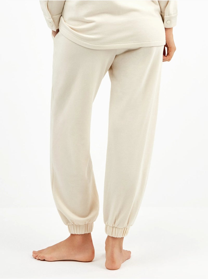 Pantalón jogger con bolsillos y cintura ajustable, en tejido de felpa Beige - Kiabi