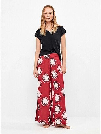 Pantalón largo ancho con estampado de soles