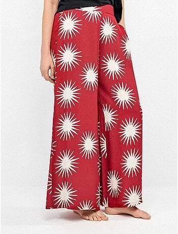 Pantalón largo ancho con estampado de soles