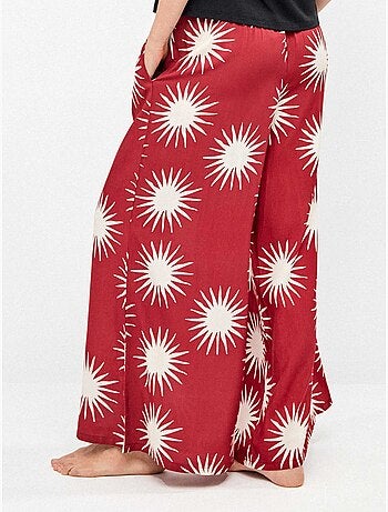 Pantalón largo ancho con estampado de soles
