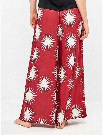 Pantalón largo ancho con estampado de soles