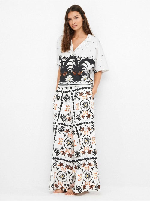 Pantalón largo ancho con estampado tropical con algodón - Kiabi Pantalón largo ancho con estampado tropical con algodón - Kiabi