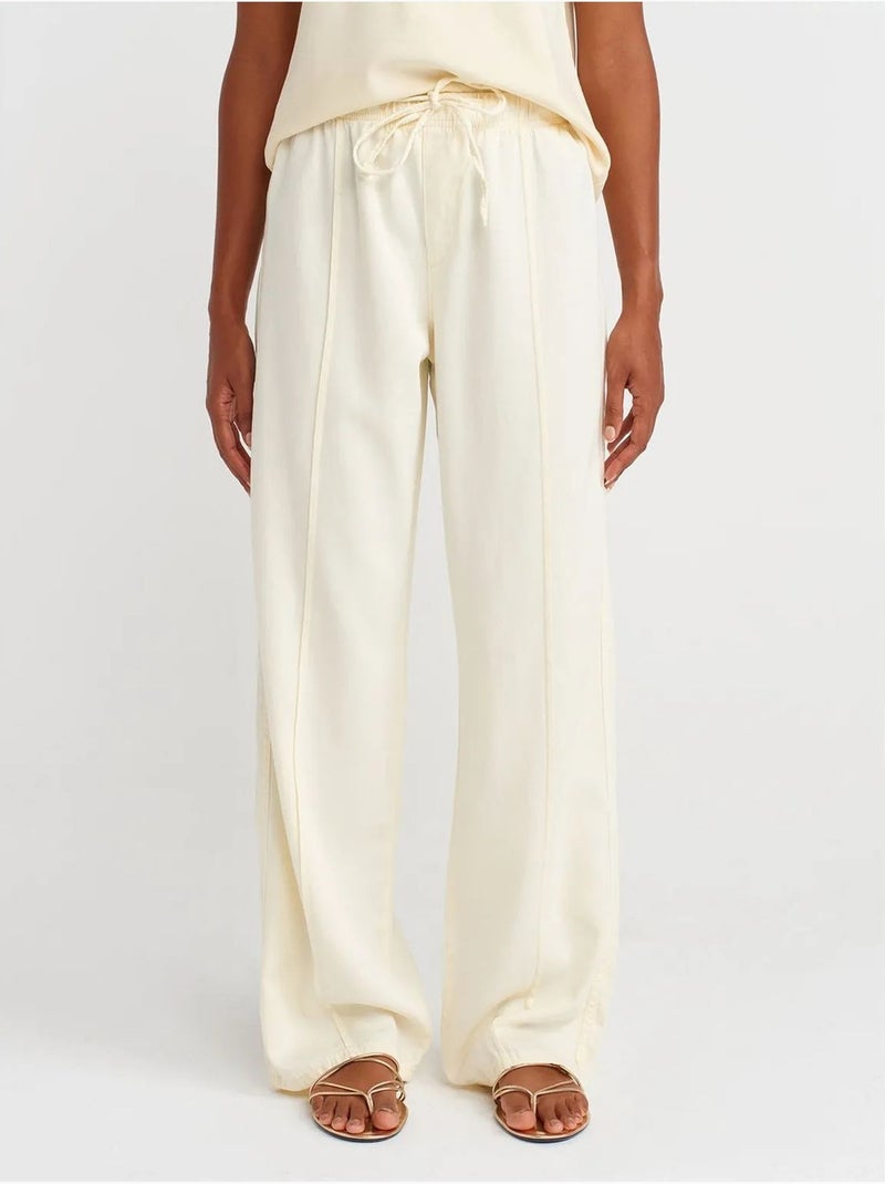 Pantalones de tiro alto y pernera ancha con cintura para anudar dilvin Crema - Kiabi