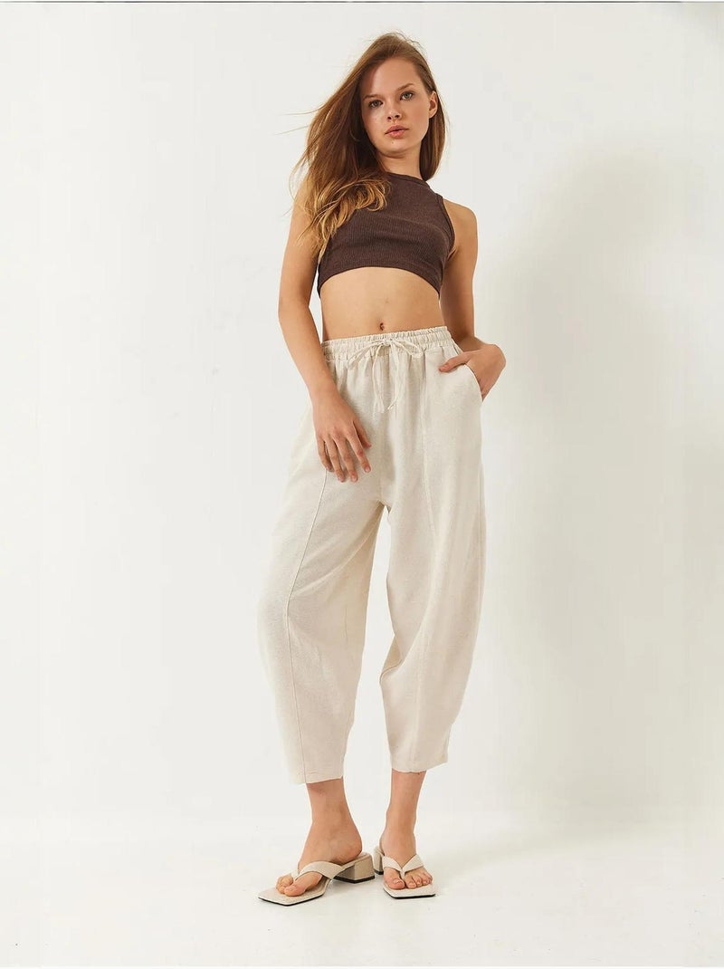 Pantalones de tiro caído con cintura elástica y detalle de bolsillo lucci Beige arcilla - Kiabi
