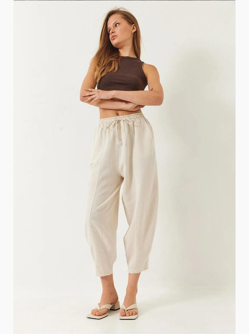 Pantalones de tiro caído con cintura elástica y detalle de bolsillo lucci Beige arcilla - Kiabi