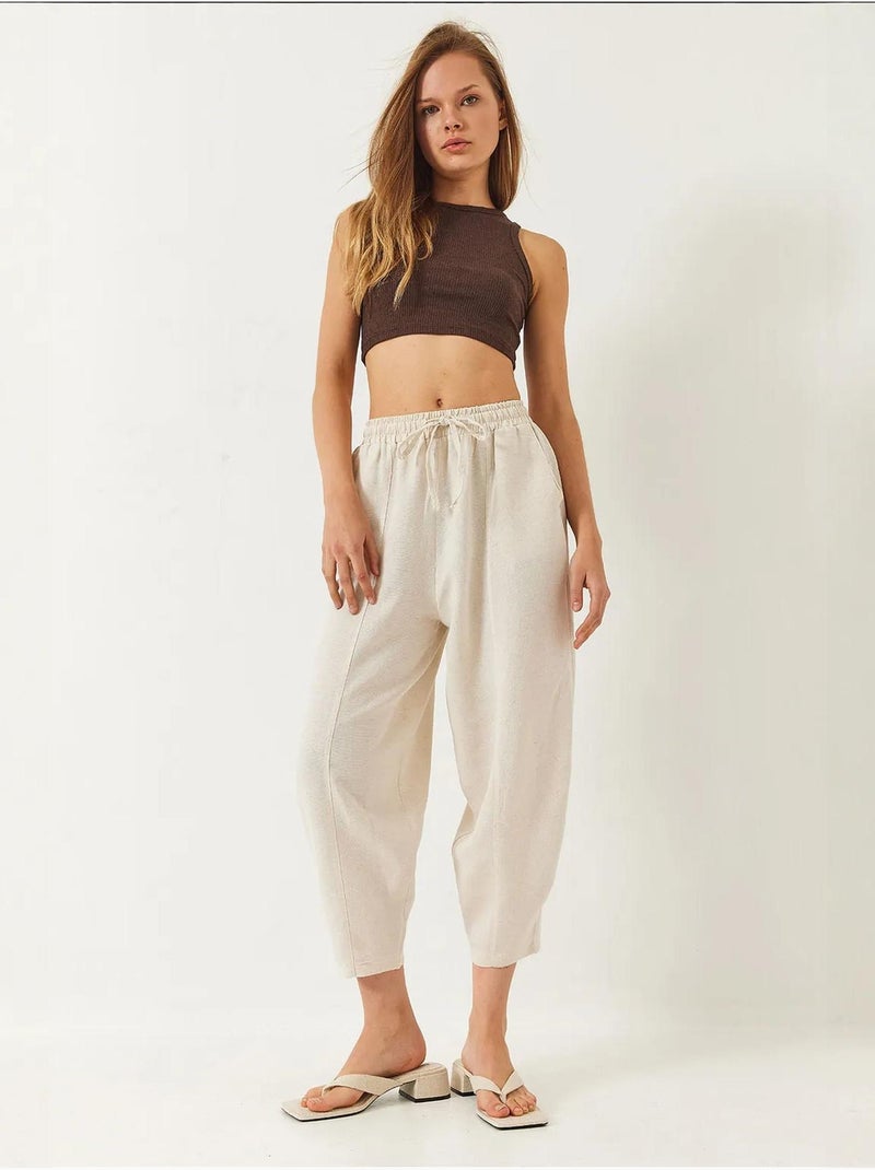 Pantalones de tiro caído con cintura elástica y detalle de bolsillo lucci Beige arcilla - Kiabi