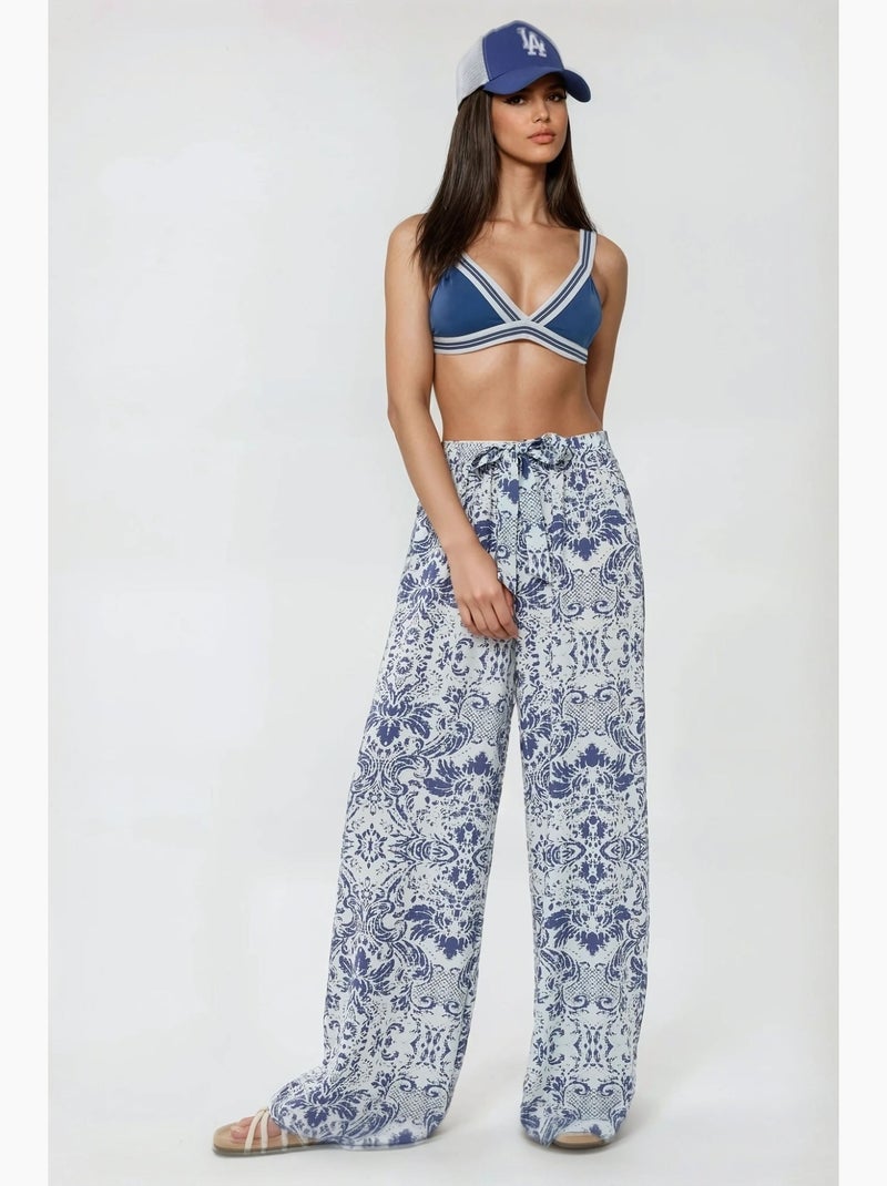 Pantalones estampados de cintura elástica y pierna ancha hiccup Blanco - Kiabi