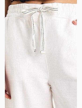 Pantalones palazzo de lino con cintura elástica y bolsillos detallados de bianco lucci