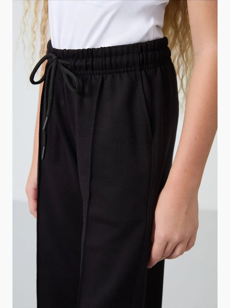 Pantalones youth unisex de mezcla de algodón tommy Negro - Kiabi