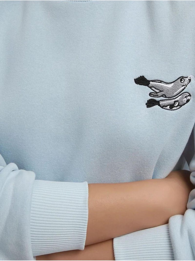 Sudadera cómoda de cuello redondo bordada con estampado animal hiccup Azul pastel - Kiabi