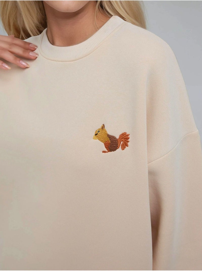 Sudadera cómoda de cuello redondo bordada con estampado animal hiccup Crema - Kiabi