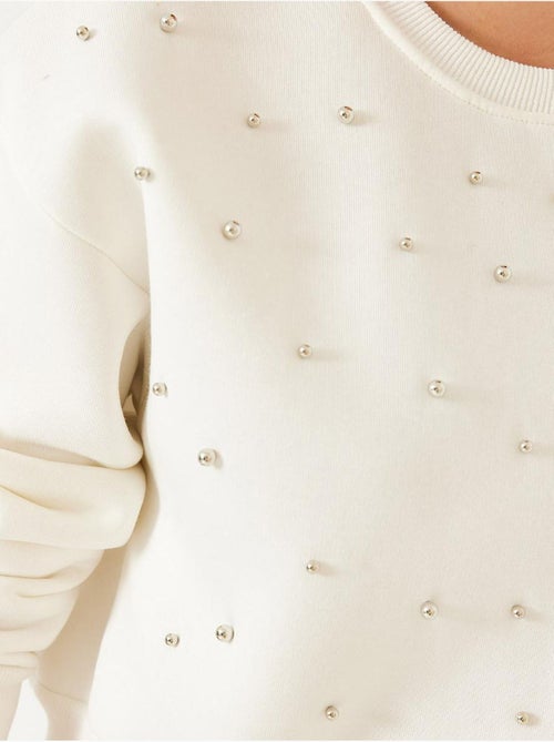 Sudadera de triple hilo cepillado con tachuelas de perlas y cuello redondo lucci - Kiabi Sudadera de triple hilo cepillado con tachuelas de perlas y cuello redondo lucci - Kiabi