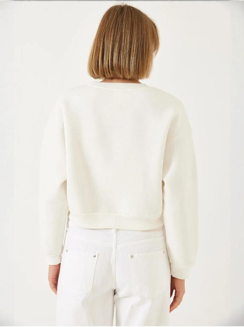 Sudadera de triple hilo cepillado con tachuelas de perlas y cuello redondo lucci - Kiabi Sudadera de triple hilo cepillado con tachuelas de perlas y cuello redondo lucci - Kiabi