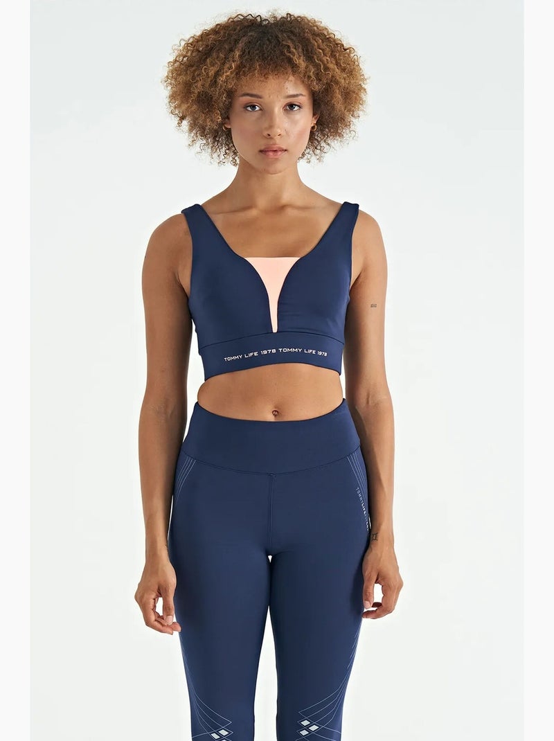 Women's top deportivo corto sin mangas con bloques de color tommy Azul Rosa - Kiabi
