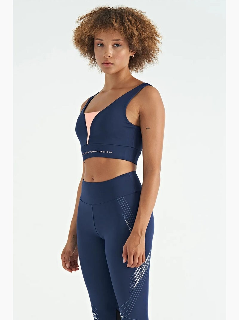 Women's top deportivo corto sin mangas con bloques de color tommy Azul Rosa - Kiabi